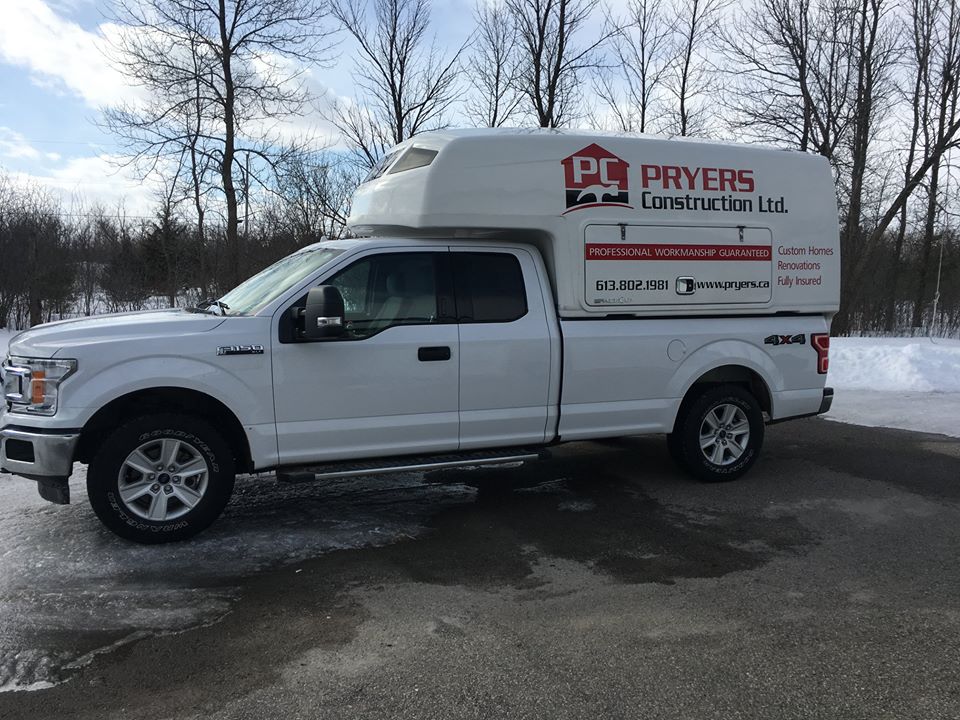 White pickup truck with Pryers Construction logo
