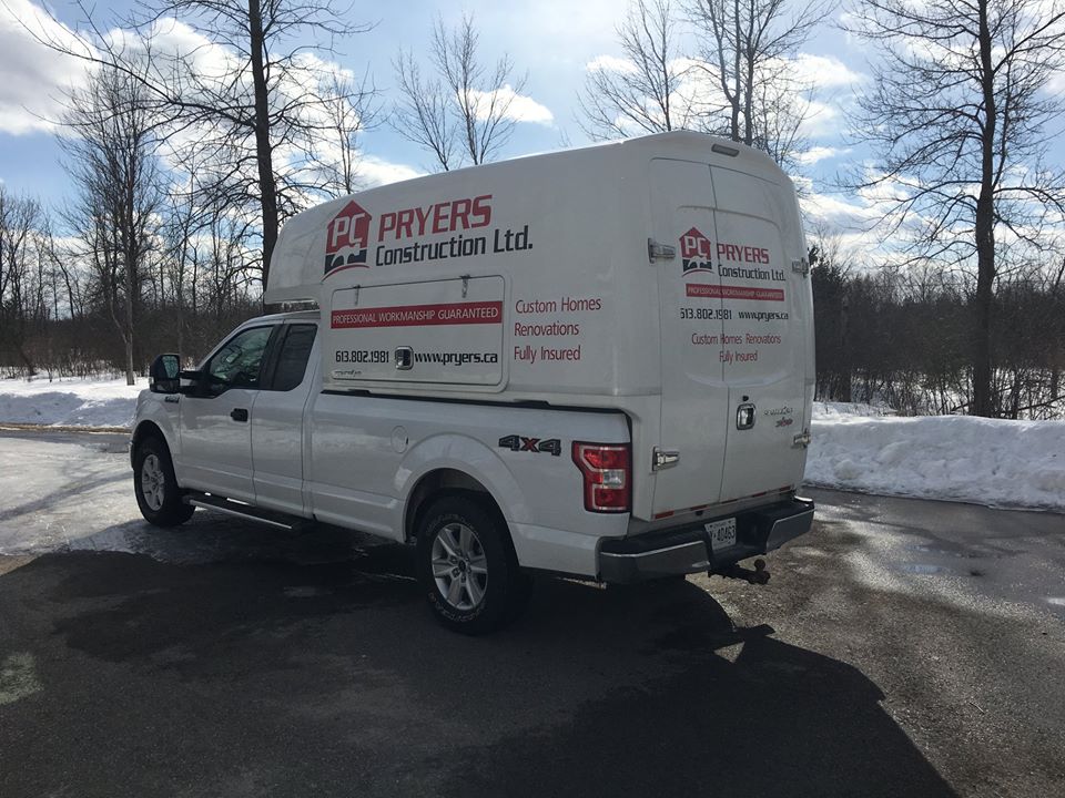 white pickup truck with Pryers Construction logo