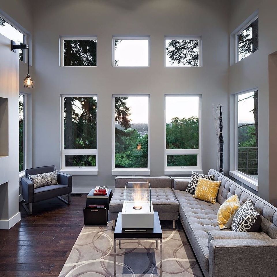 a grey sectional sofa with an arm chair