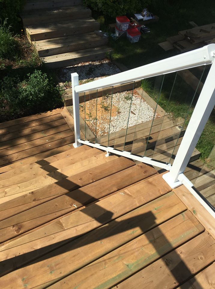 brown wooden stairs with a white railing