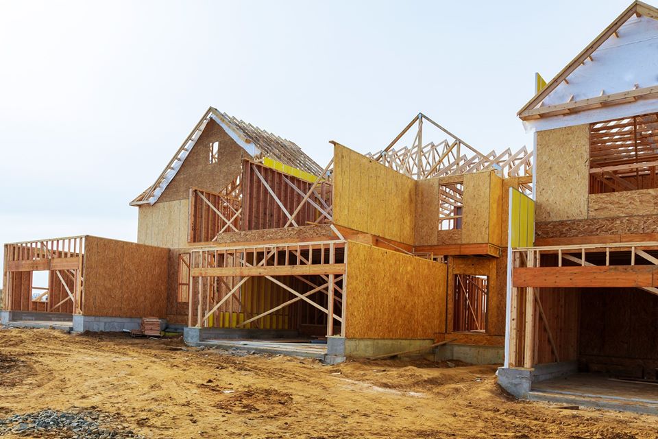 brown wooden house on brown sand during daytime