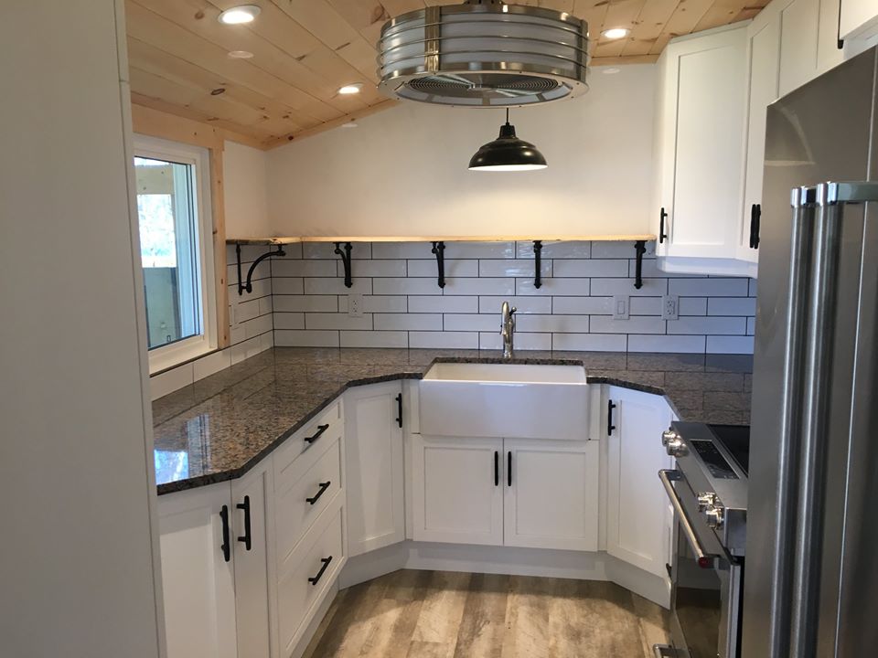 a kitchen sink with white cabinetry