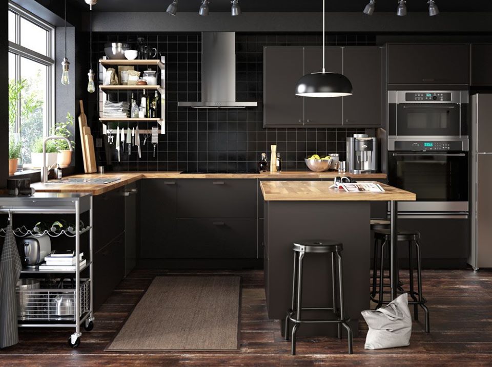 a kitchen with black cabinetry