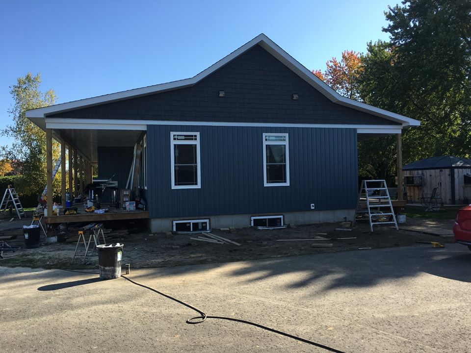 exterior photo of a one story home with blue siding