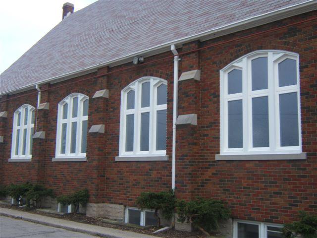 brown brick building with white wooden windows